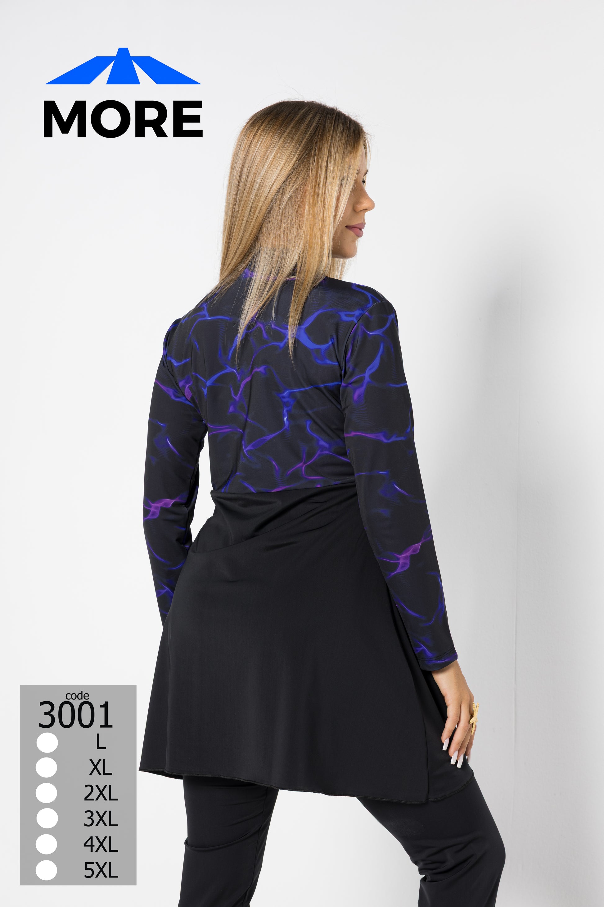 Woman wearing a black and purple patterned top with a plain white background, featuring the brand 'MORE'.