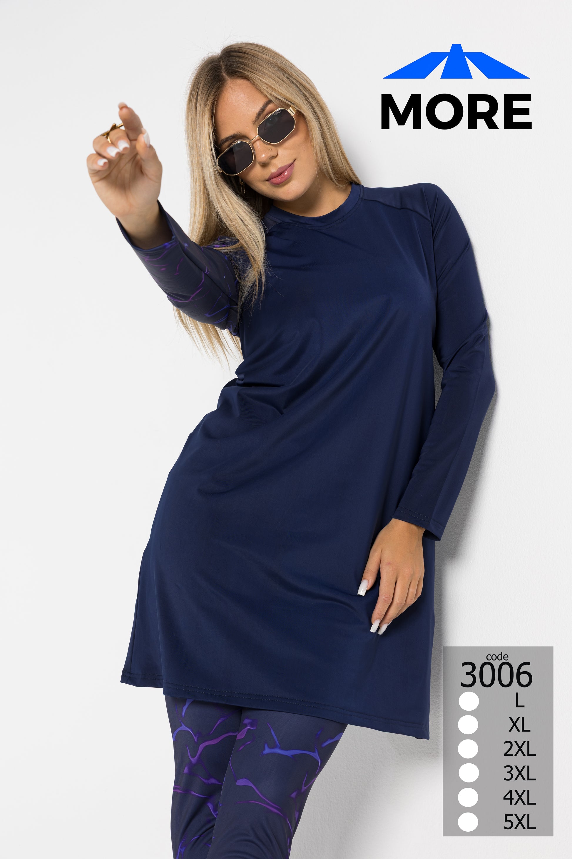 Woman wearing a navy long-sleeve top and purple leggings with sunglasses, on a white background with 'MORE' branding.