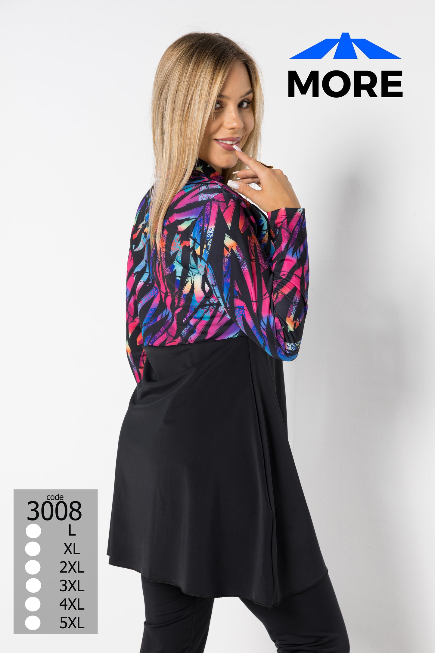 Woman wearing a colorful jacket over a black dress with 'MORE' branding on a white background.