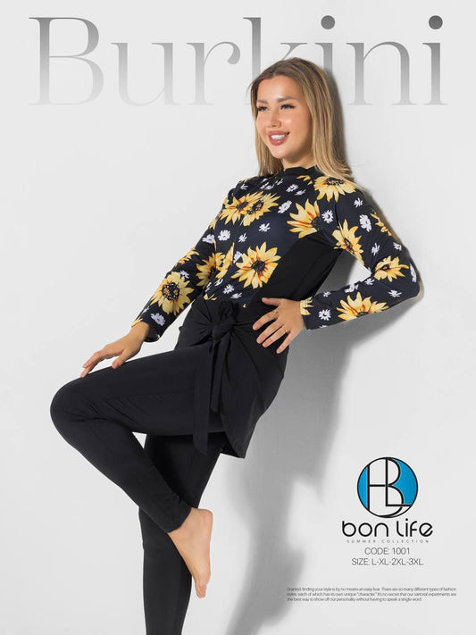 Woman wearing a floral top and black pants with 'Burkini' text and 'bon life' branding.