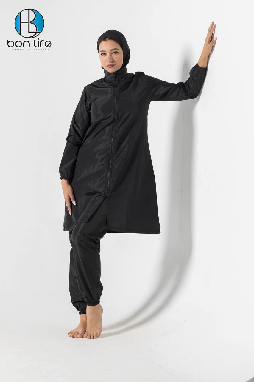 Person wearing a black outfit with a hood and long sleeves on a white background, with 'bon life' branding.