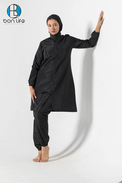 Person wearing a black outfit with a hood and long sleeves on a white background, with 'bon life' branding.