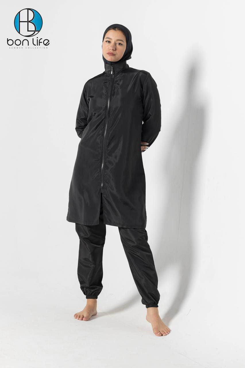 Person wearing a black raincoat and pants with a hood on a white background, featuring the brand 'bon life'.