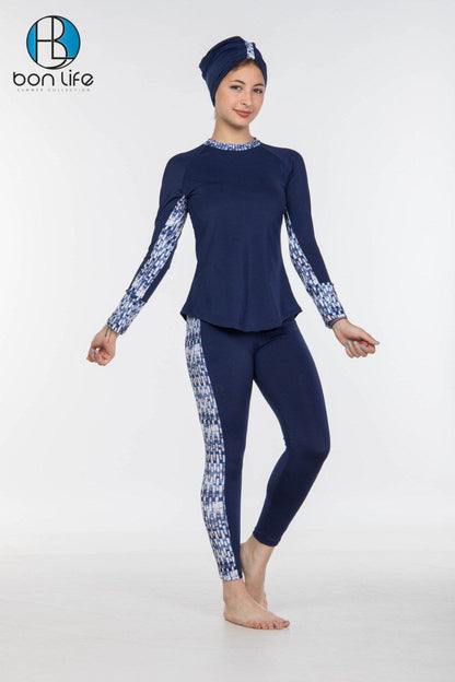 Person wearing a navy blue swimsuit with white floral patterns on a white background, featuring the brand 'bon life'.