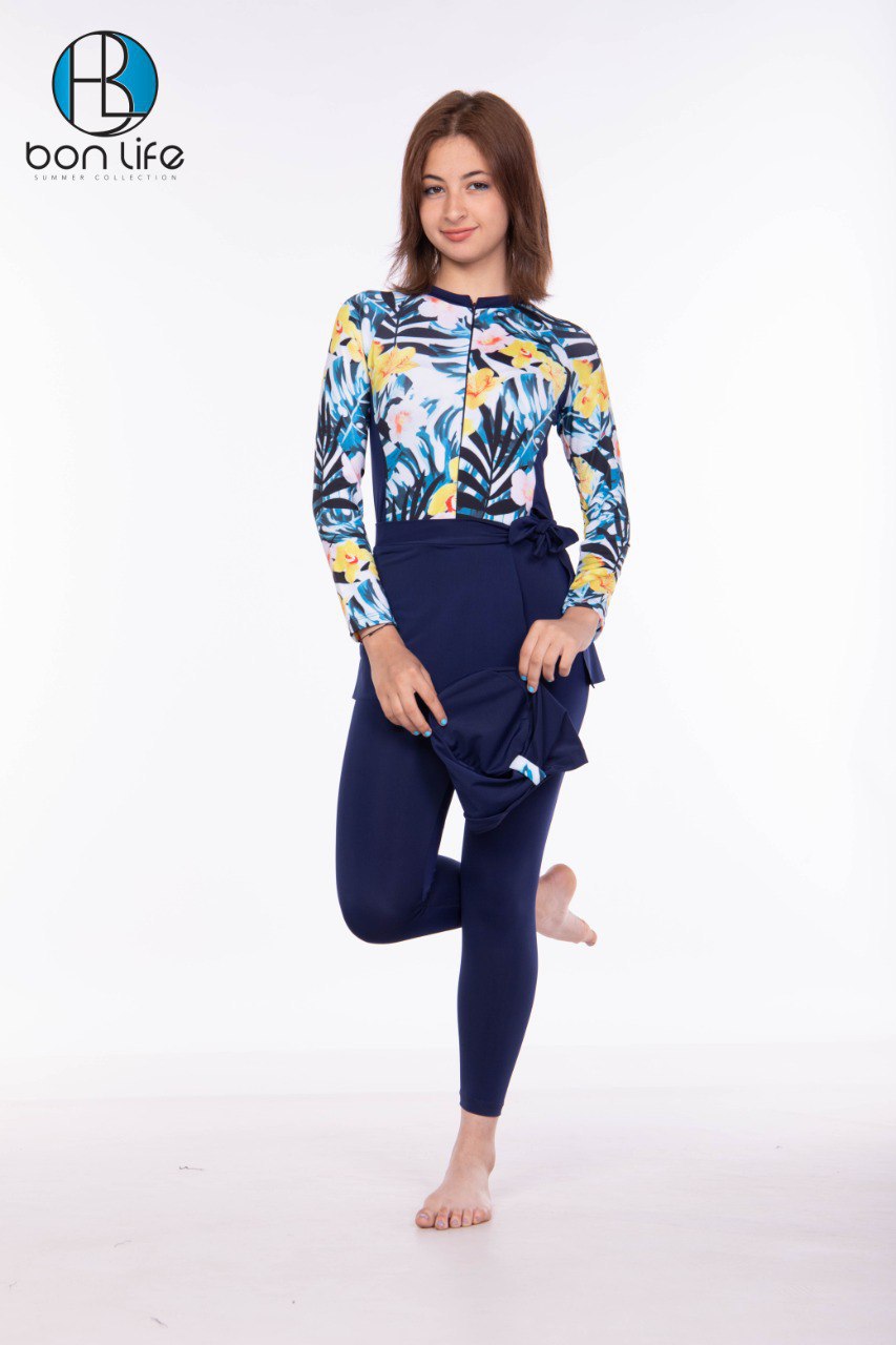 Woman wearing a colorful floral hoodie and navy leggings on a white background with 'bon life' branding.