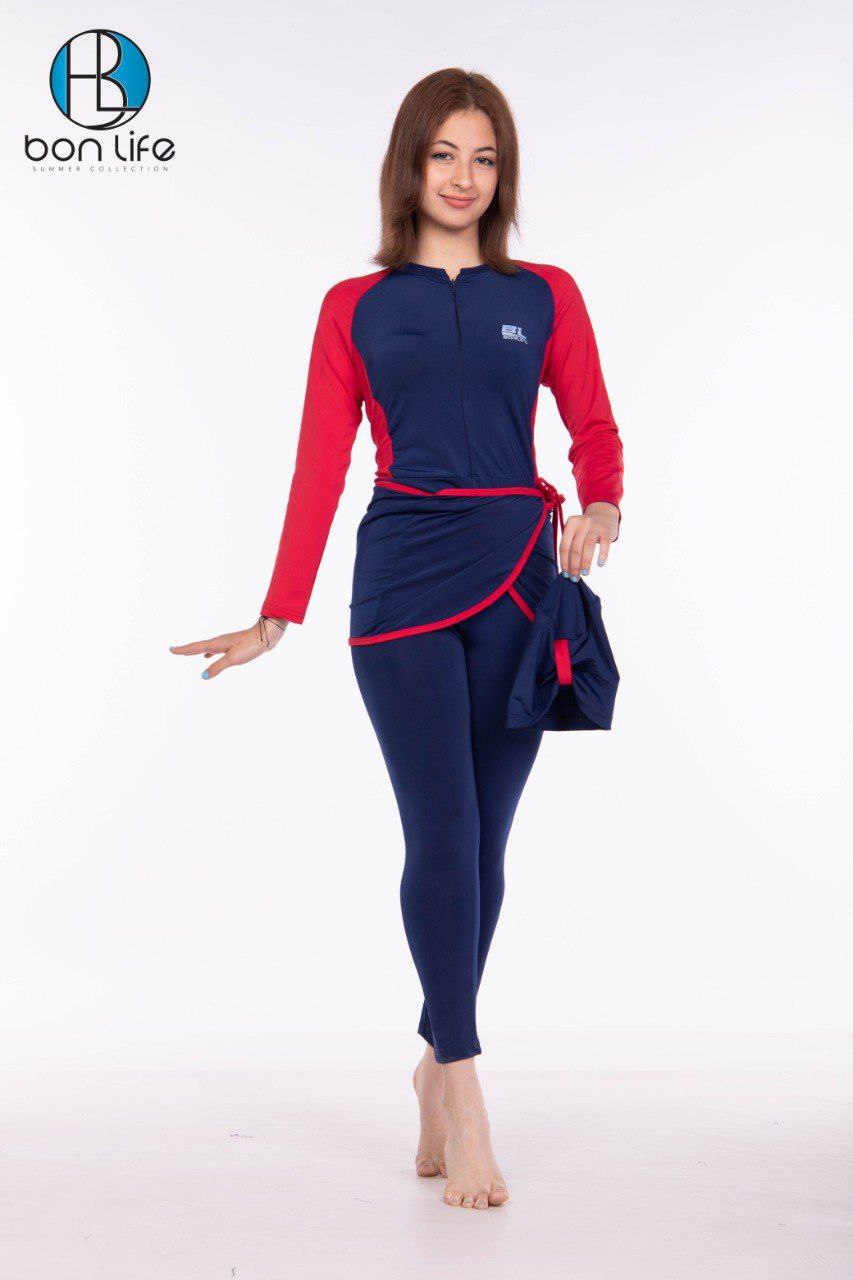 Woman wearing a navy and red swimsuit with 'bon life' branding on a white background